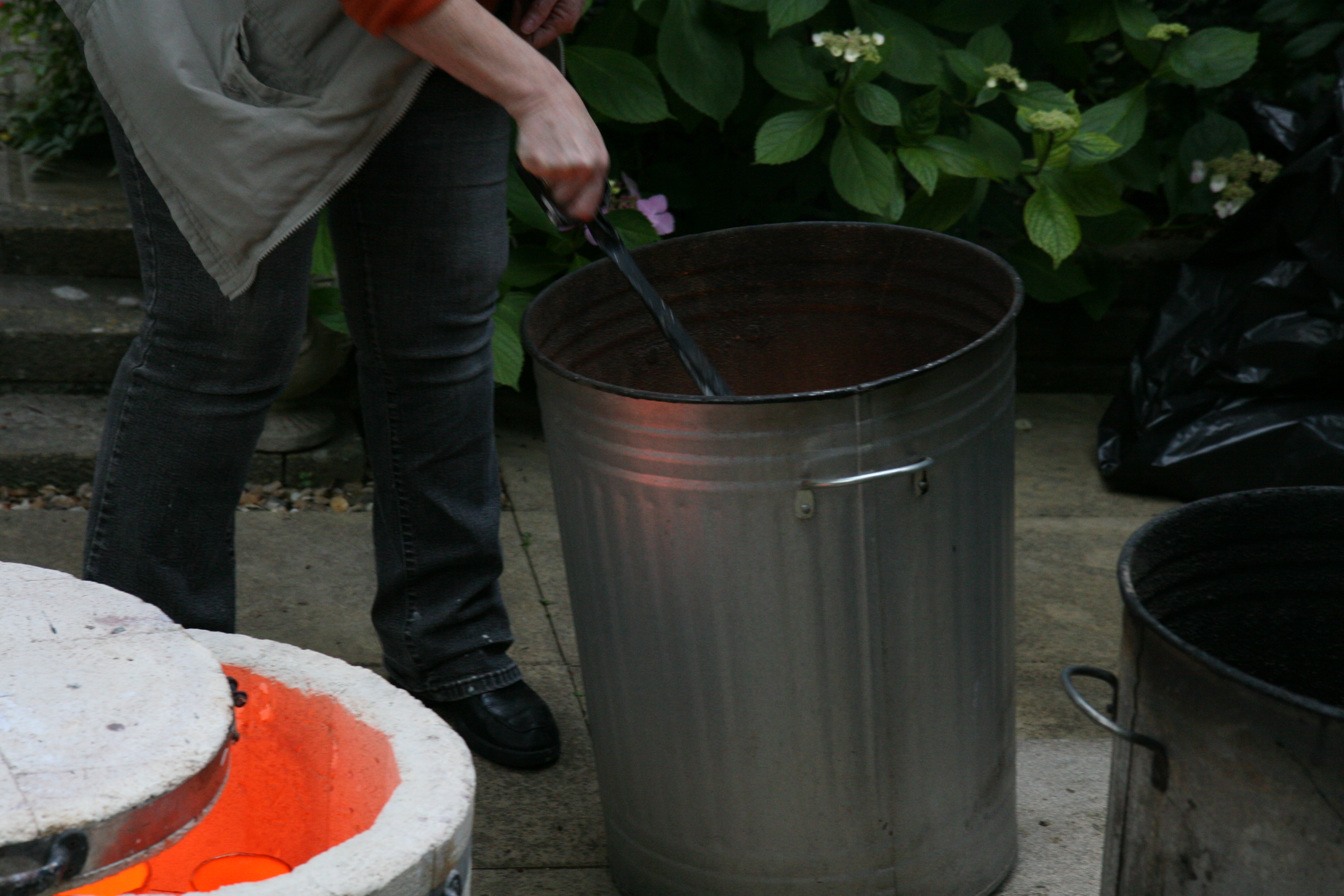 Raku Firing - placing pot in reduction chamber
